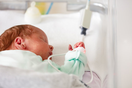 Baby In The Crib Of A Hospital ICU Room Close-up