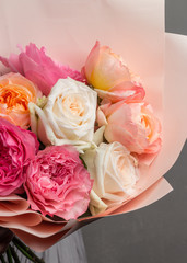 part of a lush bouquet of flowers, roses and chrysanthemums in a package