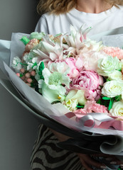 a large bouquet of flowers in their hands, a lush svabedny tender bouquet