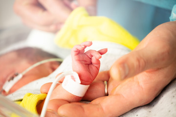 Cool newborn infant child hand and father fingers