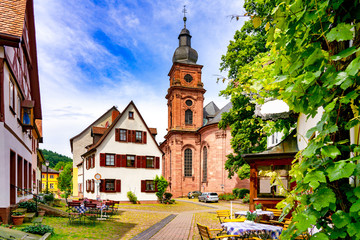 Narrow street with view of the church in the old town of Amorbach in Lower Franconia, Bavaria,...