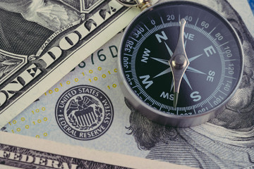 Fototapeta na wymiar FED, Federal Reserve of US government direction on interest rate concept, compass on US Dollar banknote with Feral Reserve emblem