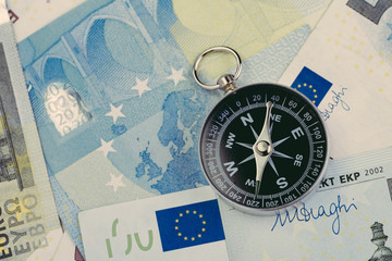 Direction of Europe and UK after brexit negotiation concept, compass on Euro banknotes with Euro flag and map of Europe and United Kingdom island