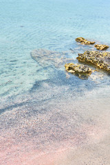 Stones and colorful sand on a tropical beach. Copy space.