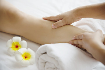 Obraz na płótnie Canvas Woman receiving foot massage service from masseuse close up at hand and foot - relax in foot massage therapy service concept