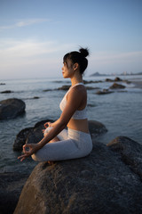 Fototapeta na wymiar Asian girl practice Yoga on the beach Sunrise morning day