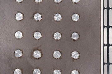 Anti slip round metal buttons on floor.