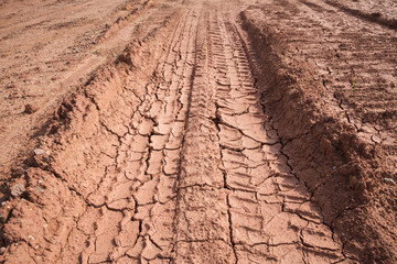 The soil pressed by the wheels has wheel marks.