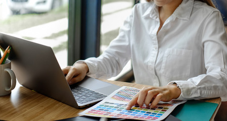 Designer female working with color samples at office