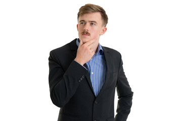Happy young businessman in suit looking up on white background, isolated concept