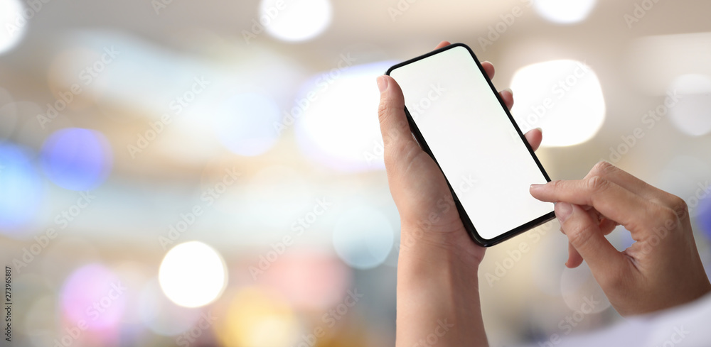 Poster man with mobile phone showing blank screen over bokeh background