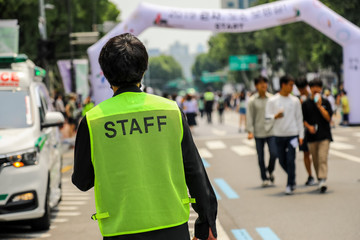 man with staff vest