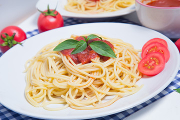 Spaghetti pasta with and tomato sauce on wood background