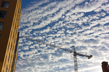 Building development with working crane under cloudy skies, Washington DC, USA.