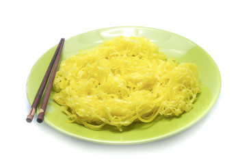 yellow noodles on dish isolated on white background