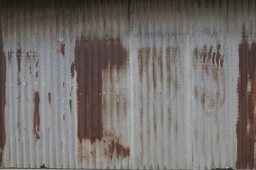 Old zing wall,background of peeling paint and rusty old metal.zinc wall texture pattern background rusty corrugated metal old decay.