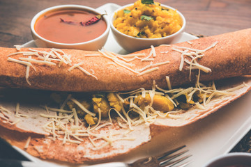cheese masala dosa recipe with sambar and chutney, selective focus