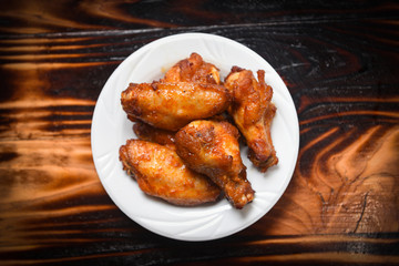 Baked chicken wing bbq grill on plate / hot and spicy chicken on dark background