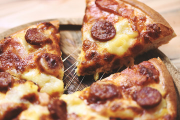 Pizza on wooden tray close up / delicious tasty fast food italian traditional pizza cheese