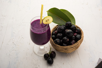 Juice of jamun fruit in a glass also called as java plum, jambolan plum, jambhul, syzygium cumini