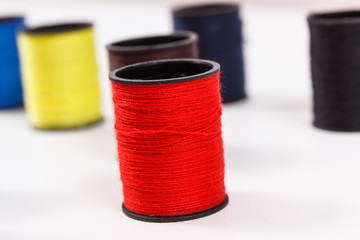 Spools of colorful thread as accessories for using in sewing.