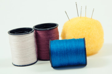 Spools of thread and needle using for embroidery and sewing