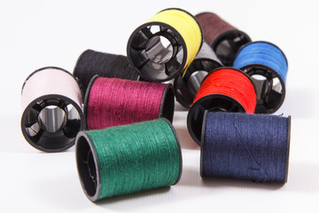 Spools of colorful thread as accessories for using in sewing.