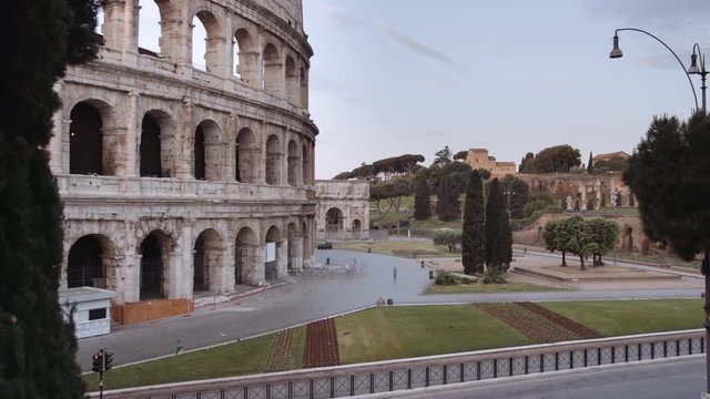In a semi-abandoned Rome a survivor walks near Coliseum "Colosseo Anfiteatro Flavio". Birds passing by. Rome Italy. Shot on Red Monstro 8K. In 4K