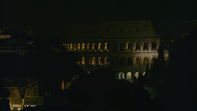 Coliseum "Colosseo, Anfiteatro Flavio" zoom in from Vittoriano Monument at night with low lights. Shot on Red Monstro 8K. in 4K