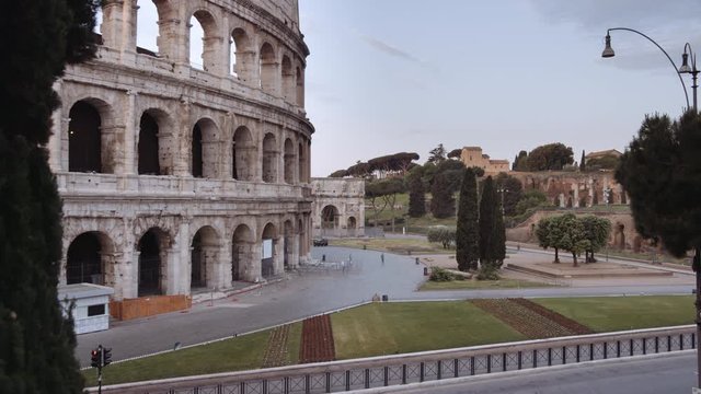In a semi-abandoned Rome a survivor walks near Coliseum "Colosseo Anfiteatro Flavio". Birds passing by. Rome Italy. Shot on Red Monstro 8K. In 4K