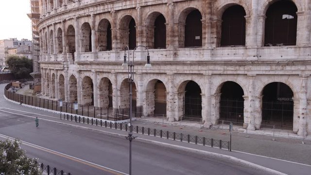 In a semi-abandoned Rome a survivor walks near Coliseum "Colosseo Anfiteatro Flavio". Birds passing by. Rome Italy. Shot on Red Monstro 8K. In 4K