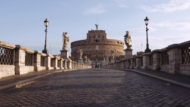 In a semi-abandoned Rome a survivor walks towards "Saint Angel Castle" Castel Sant Angelo and bridge Ponte Sant Angelo over the Tiber river. Birds passing by. Shot on Red Monstro 8K. In 4K