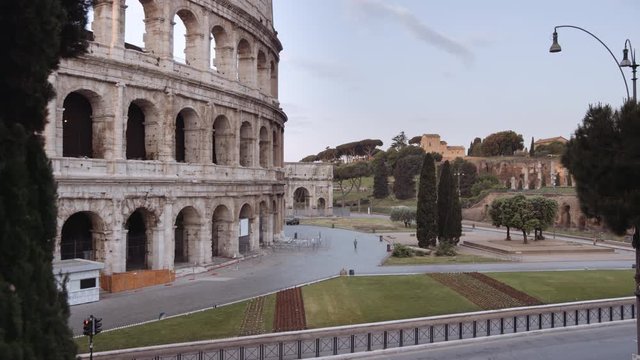In a semi-abandoned Rome a survivor walks near Coliseum "Colosseo Anfiteatro Flavio". Birds passing by. Rome Italy. Shot on Red Monstro 8K. In 4K