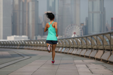 Naklejka premium Healthy lifestyle woman runner running at hong kong city in the morning