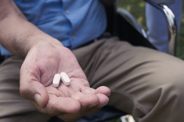 hand of senior man give a medecine for health care