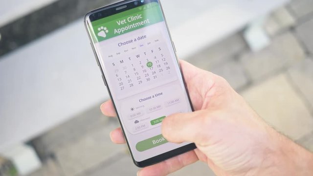 Using an online appointment app to schedule a rendezvous to the vetenerian pet doctor on a smartphone screen.
