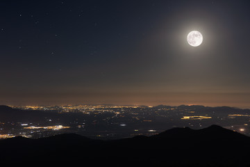 A beautiful full moon night in June in Spain with a view towards Cartagena. From the summit of...