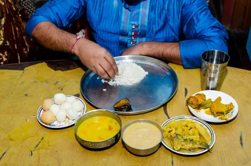 Foto op Canvas Indian food and sweets in dinner table with rice, curry and fish fry © Abhishek Kumar Sah