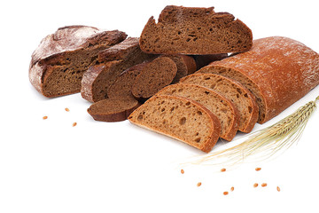 Rye bread, ears of rye and slices on a white background.High fiber content. The concept of a balanced diet. Selective focus, layout, side view.