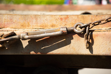 Anchor bolt holds a rusty chain taut