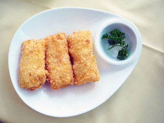 Deep fried bean curd stuffed with shrimp served with sweet and sour plum sauce. Selective focus.