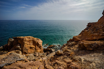 Fototapeta na wymiar High rocky coast and sea waves of the Mediterranean sea.
