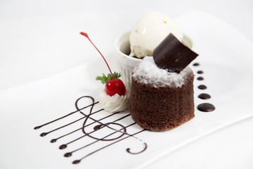 Chocolate cake with melted chocolate and red cherry