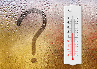 Rainy day. Question mark symbol written on glass. Thermometer for measuring air temperature shows...
