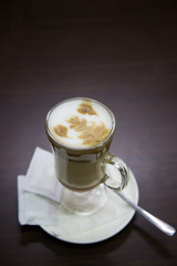 Iced coffee cappuccino latte art with condiment on a table