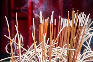 Incense sticks close-up in the Temple of Literature (Quoc Tu Giam), Hanoi, Vietnam. Horizontal view.