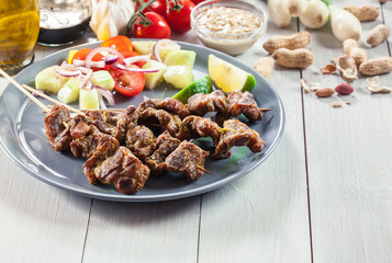 Traditional pork satay with peanut sauce and vegetables