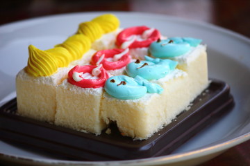 Slice cake piece with cream on top