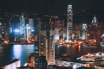 Hong Kong city’s skyline at night, shot from Kowloon side. Showing skyscrapers in a dynamic colour tone surrounding the famous Victoria Habour.