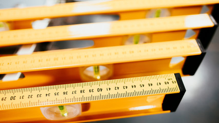 Closeup of construction level rulers displayed in the tool store. Handyman measurement instrument.